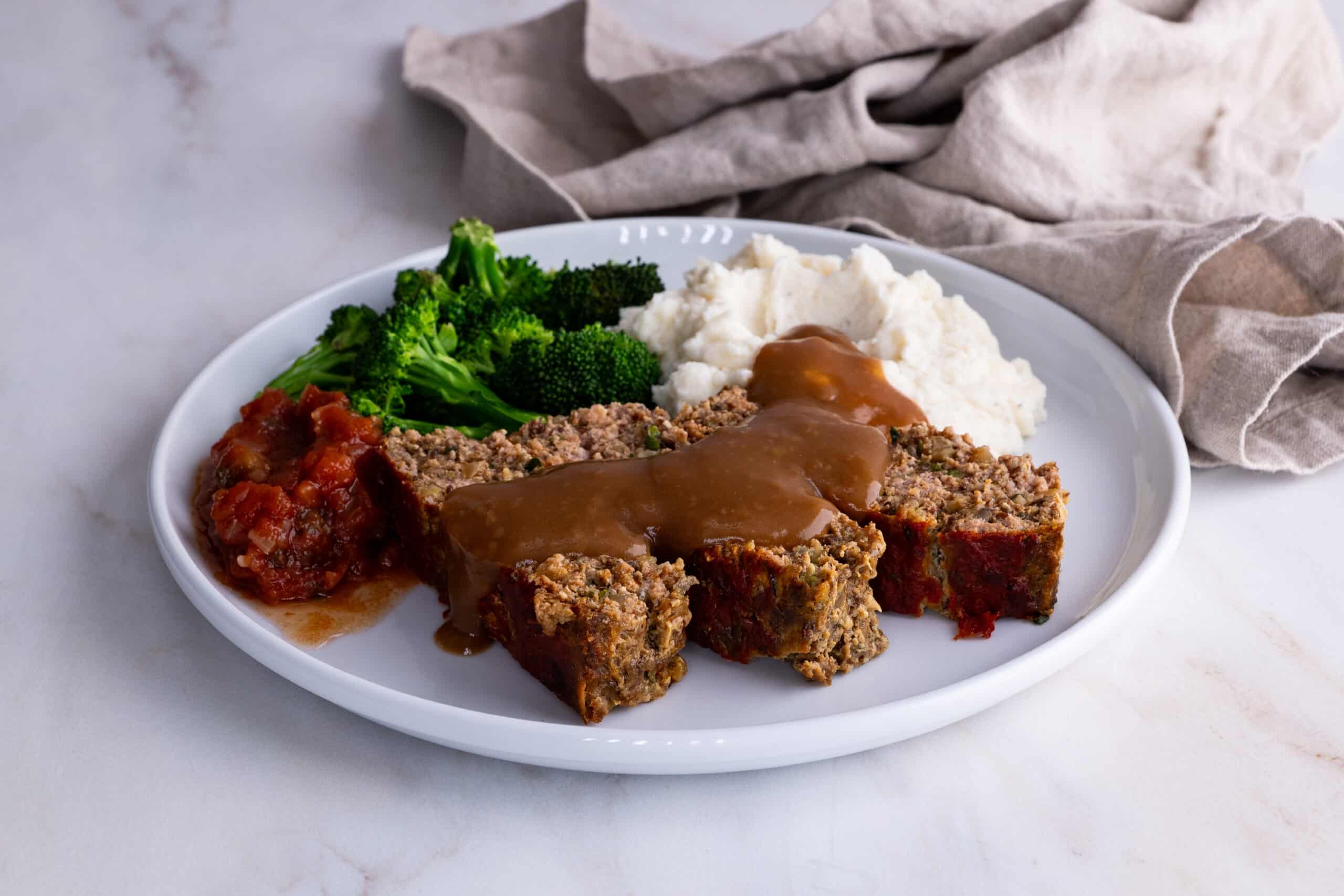 Turkey Meatloaf Plated with gravy, and broccoli