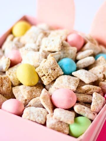 A container full of Easter bunny chow with chex mix.