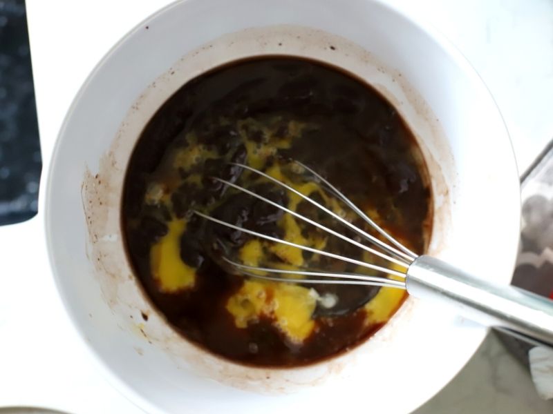 Eggs being added to brownie batter