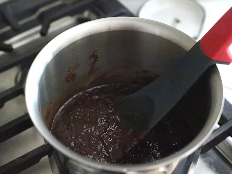 dark chocolate and sugar being heated on the stove