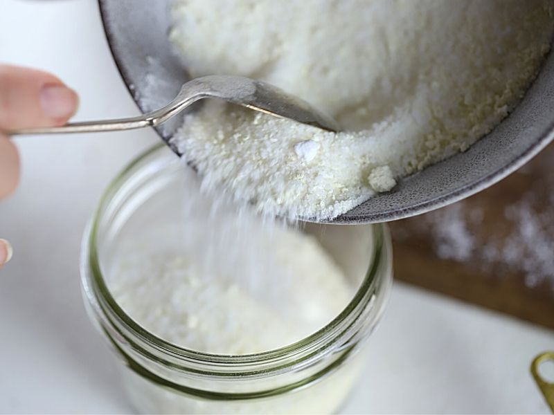 Foot soak ingredients being added to jar