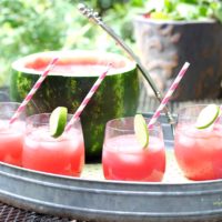 Watermelon Punch with stripped straws in a serving tray