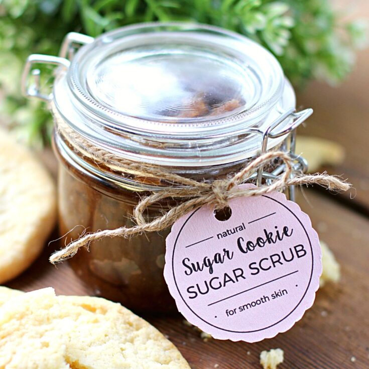 A sugar scrub in a glass jar with a label attached with twine.