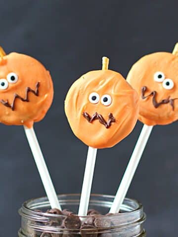 Oreo cookie pumpkins on a stick.