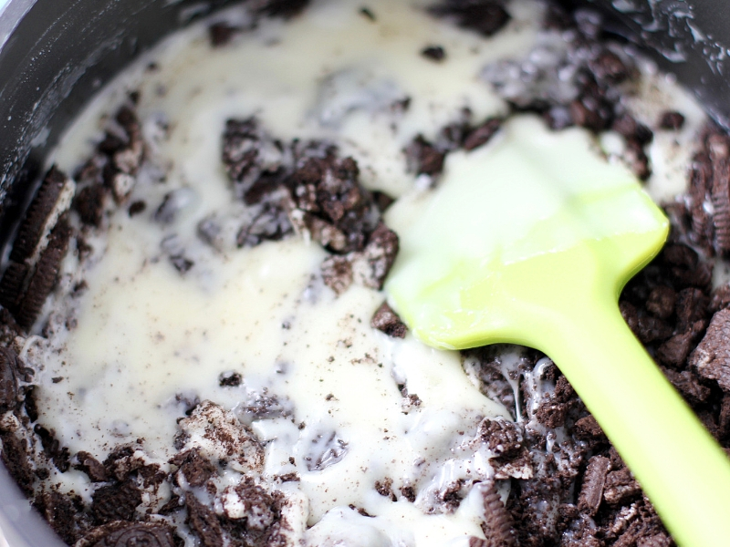 Oreo Cookie pieces being mixed into Oreo Fudge