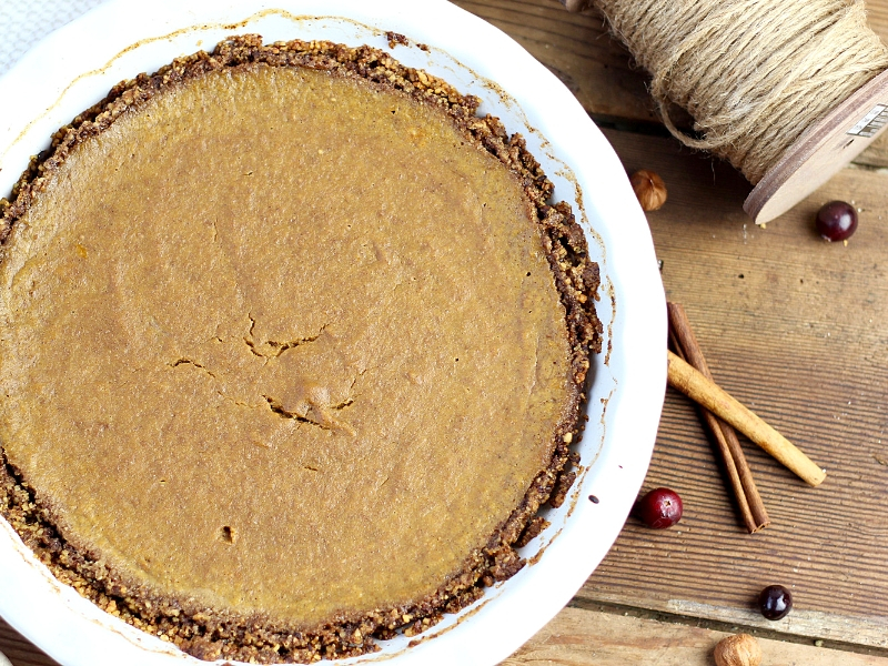 Paleo pumpkin pie on a wooden cutting board