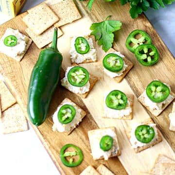 Crackers topped with cream cheese, Mexican cheese, and Jalapenos.