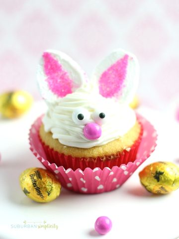 Bunny cupcake in a pink wrapper and Butterfinger candies next to it.