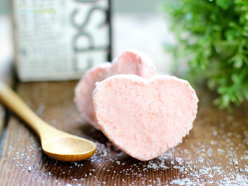 Pink heart shaped bath bombs with a spoon laying next to them.