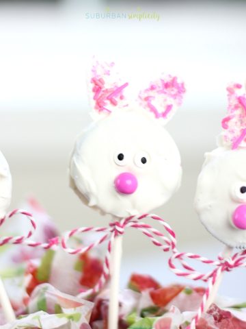 An adorable Easter bunny Oreo cookie pop with a ribbon around the stick.