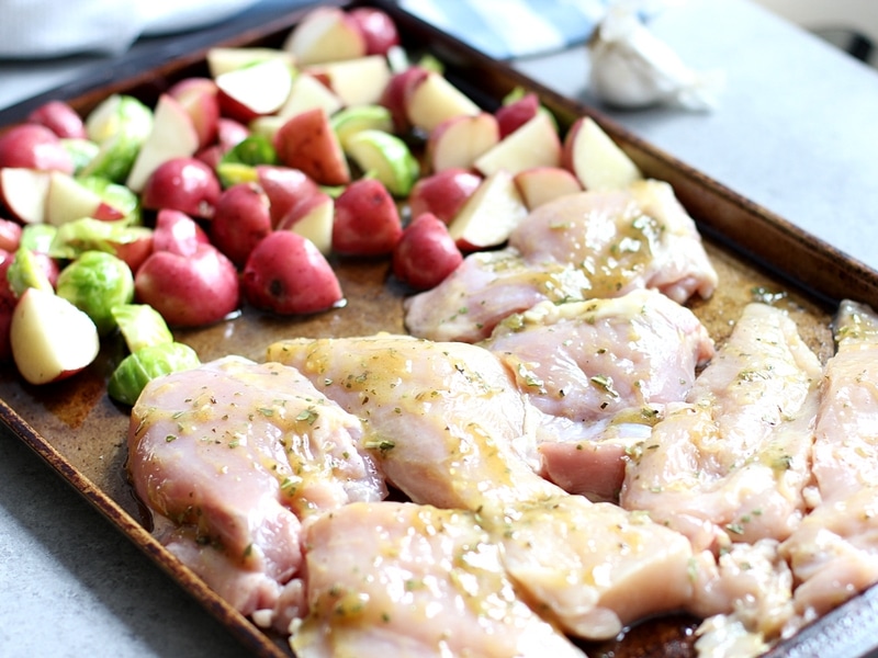 Vegetable and chicken in a pan ready to go in the oven.