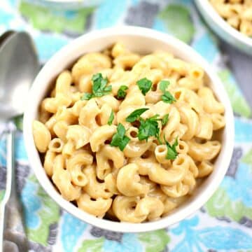 Bowl of instant pot macaroni and cheese with parsley on top.