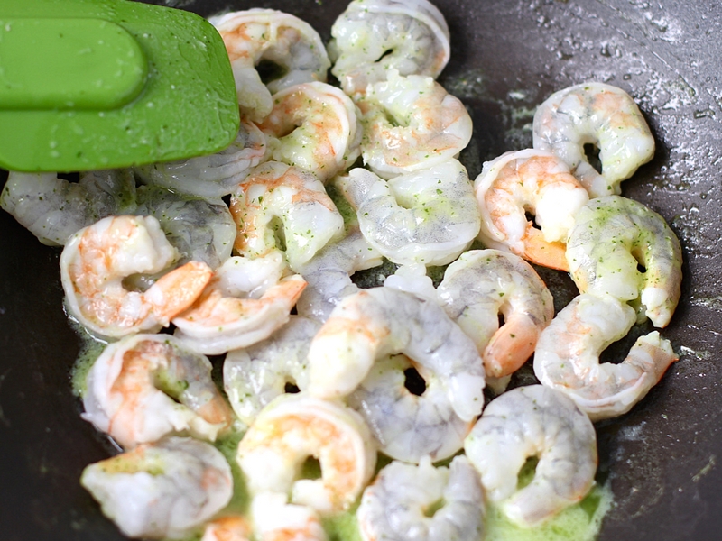 Raw shrimp cooking in a pan. 