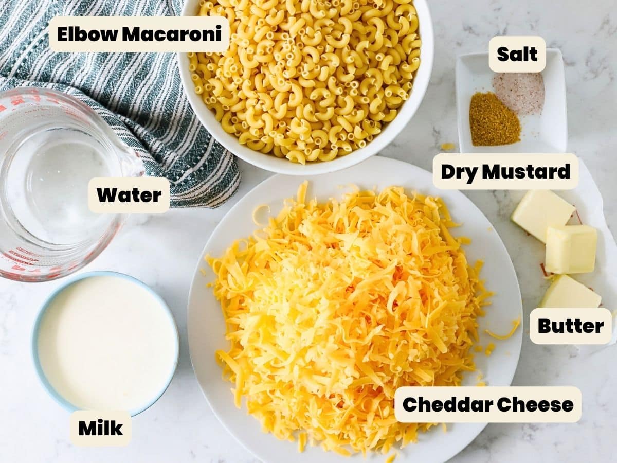 Ingredients to make instant pot mac and cheese on the table with text labels.