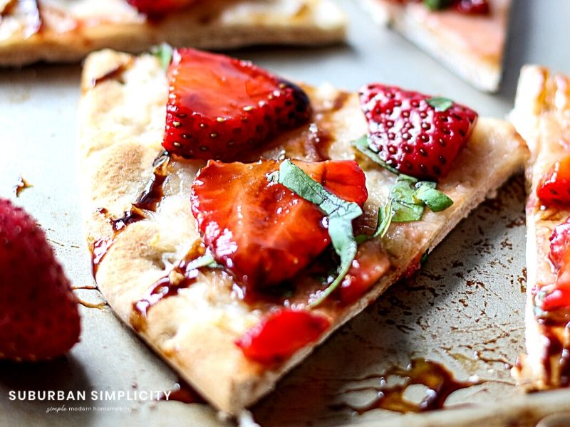 Strawberry Balsamic Flatbread is an easy recipe with lots of sweet and savory flavors. Fresh strawberries and basil on top crispy baked flatbread. The perfect summer appetizer, snack or meal! 