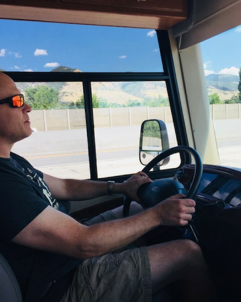 Dad driving an RV with kids.