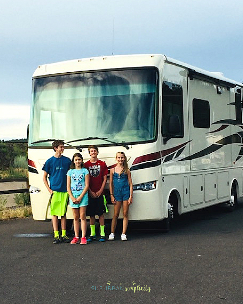 RV with kids standing in front.