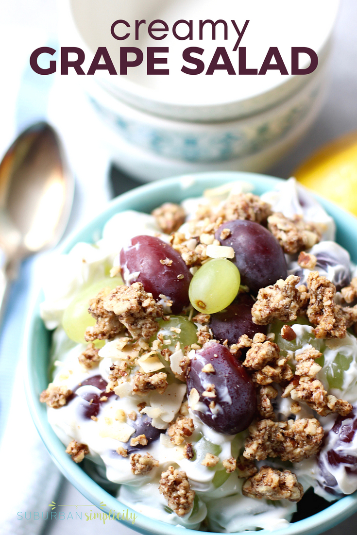 Creamy grape salad in a bowl with granola topping.