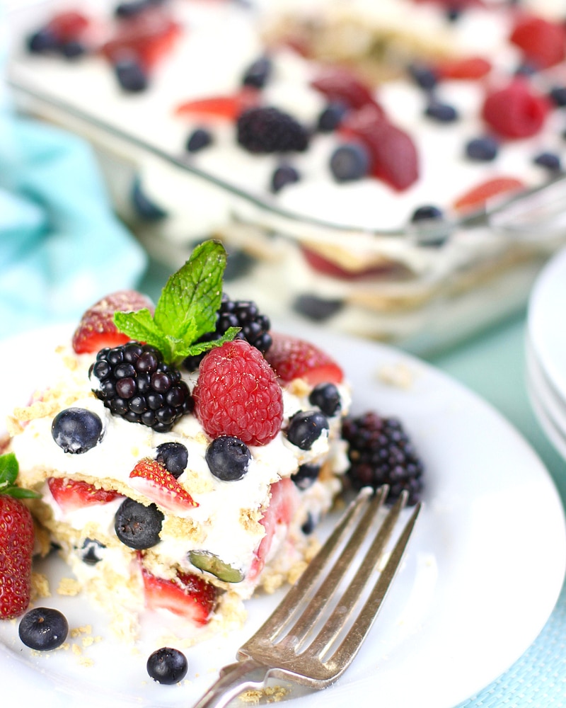 Slice of Summer Berry Icebox Cake in front of the pan of cake.