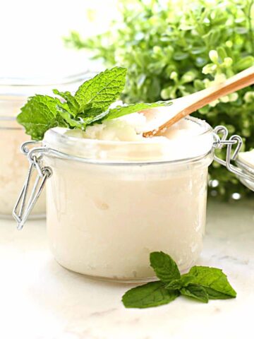 a Jar with peppermint sugar scrub with a wooden spoon in it.