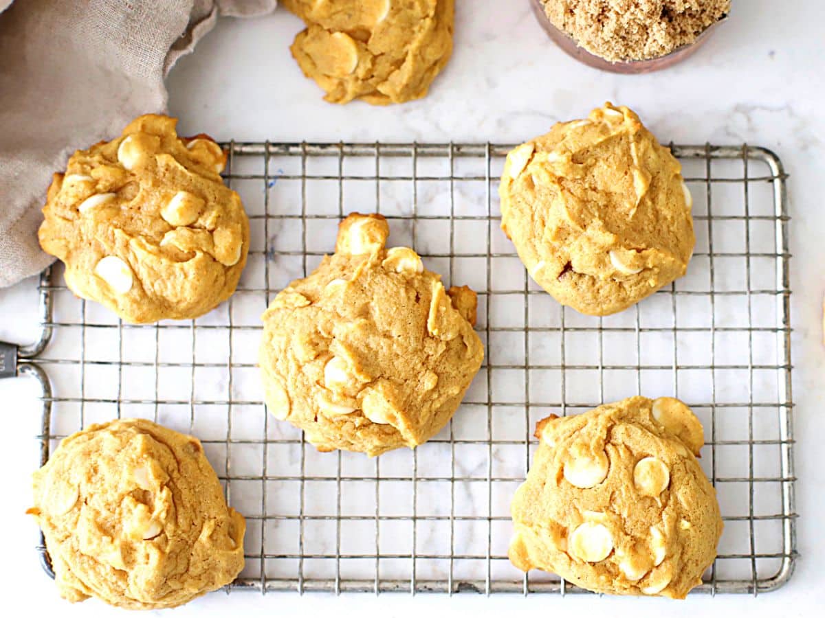 Pumpkin cookies on a cooling rack.