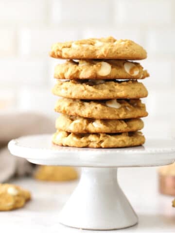 Pumpkin spice cookies stacked on a cake stand.