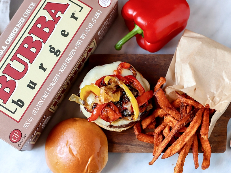 Open-face burger topped with cheese and onions.