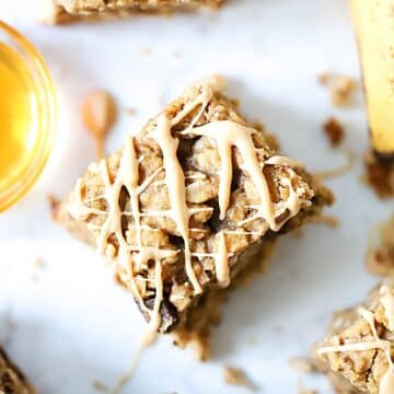 Top down view of a banana bar with peanut butter drizzled over top.