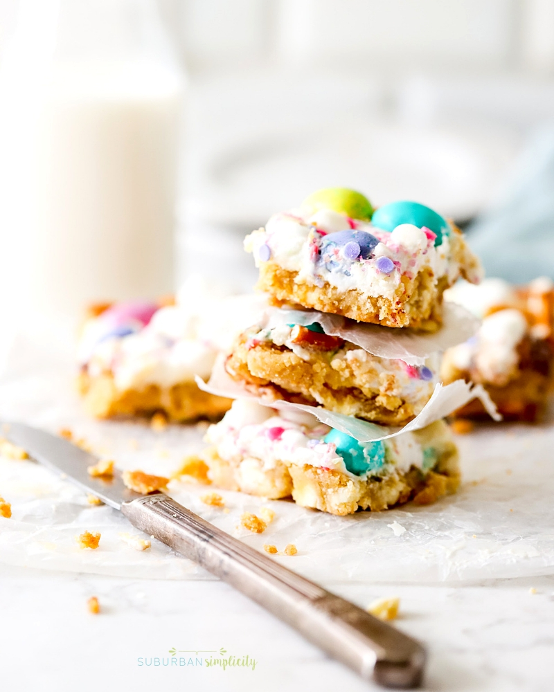 Spring Confetti Cookies Bars are the perfect Easter dessert recipe!  Sugar cookie dough topped with fluffy marshmallows, spring candy and salty pretzels. 