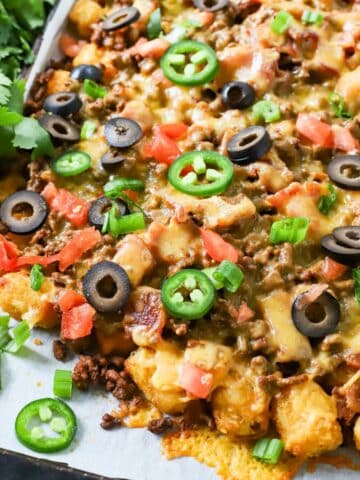 Baked tater tot appetizer on a sheet pan.