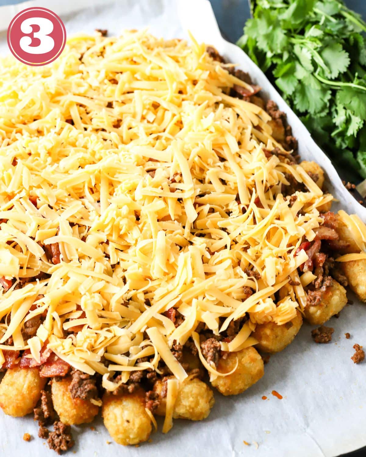 Tater tot nachos ready to be baked in the oven.