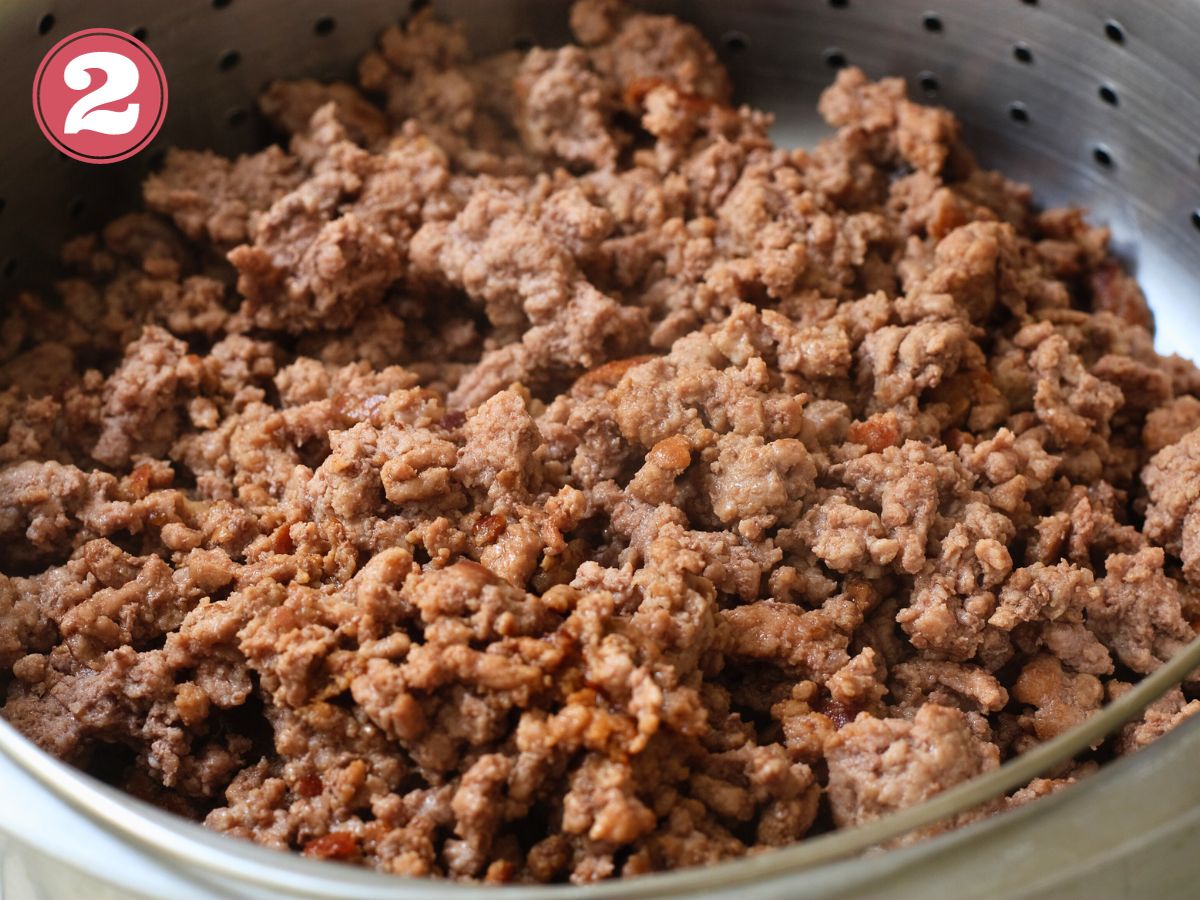 Skillet with cooked ground beef and tacon seasoning.