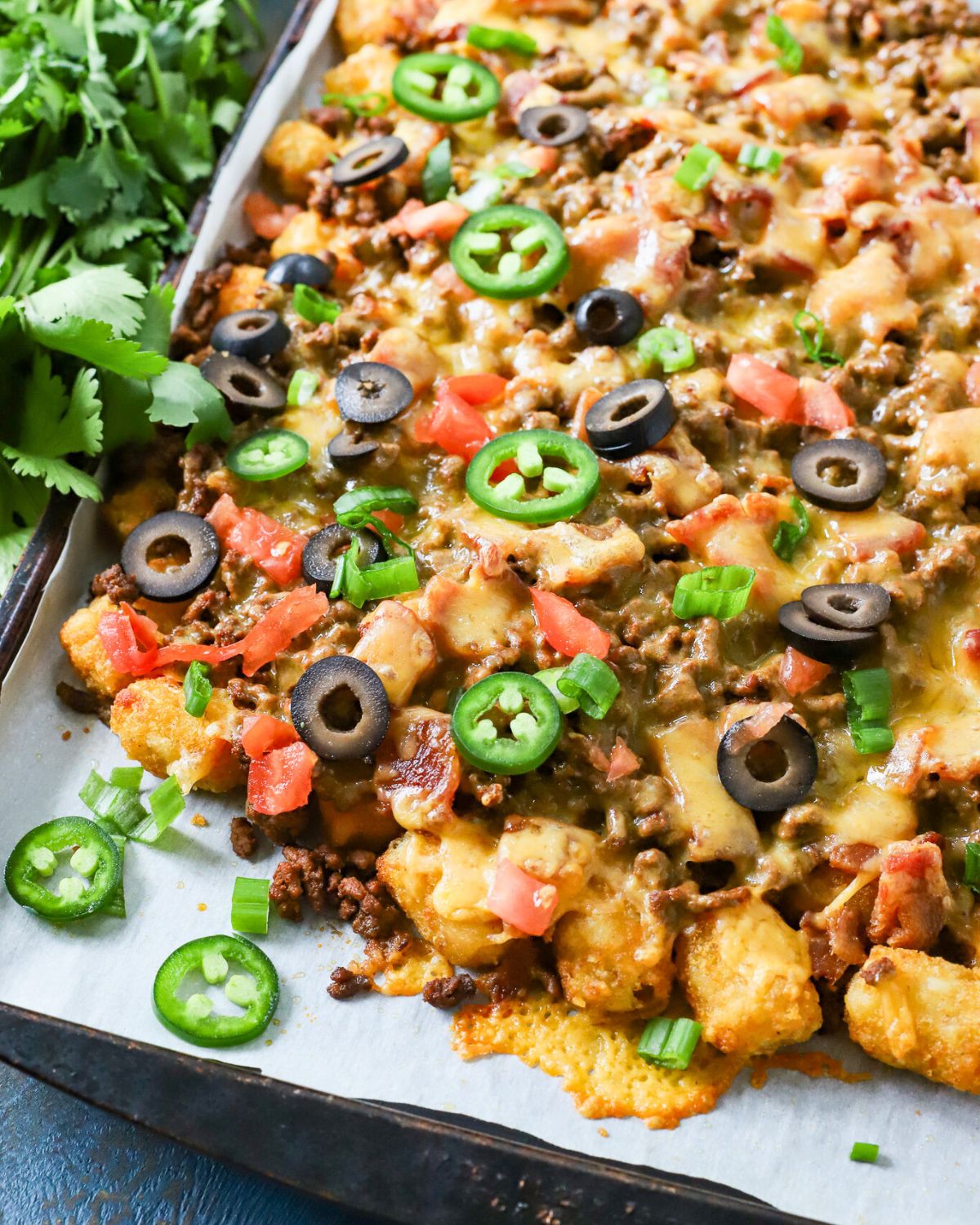 Sheet pan with loaded tater tot nachos.