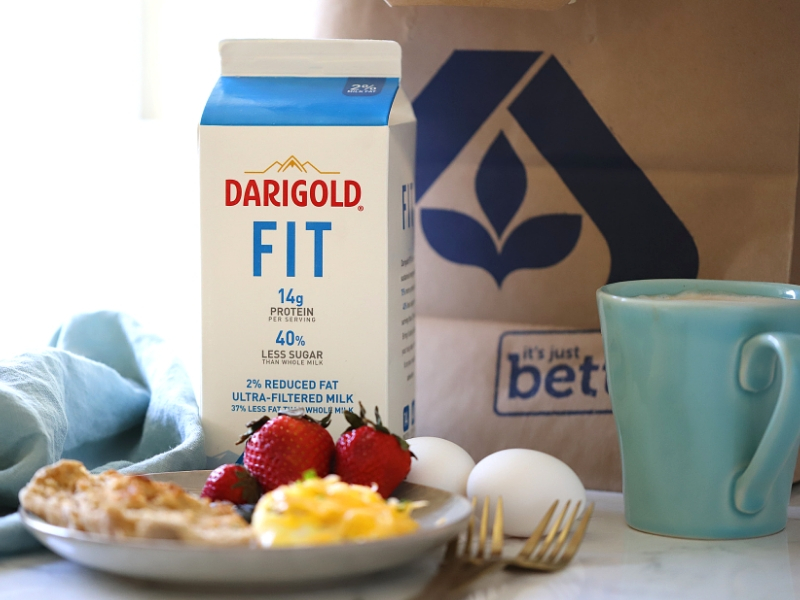 Darigold FIT milk next to a sausage and cheese omelet.