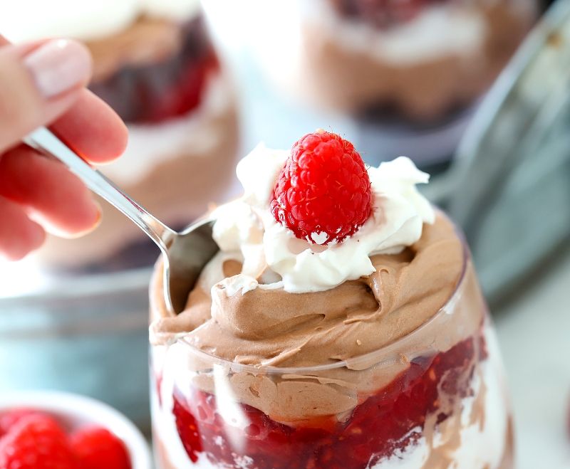 Someone eating a chocolate raspberry trifle