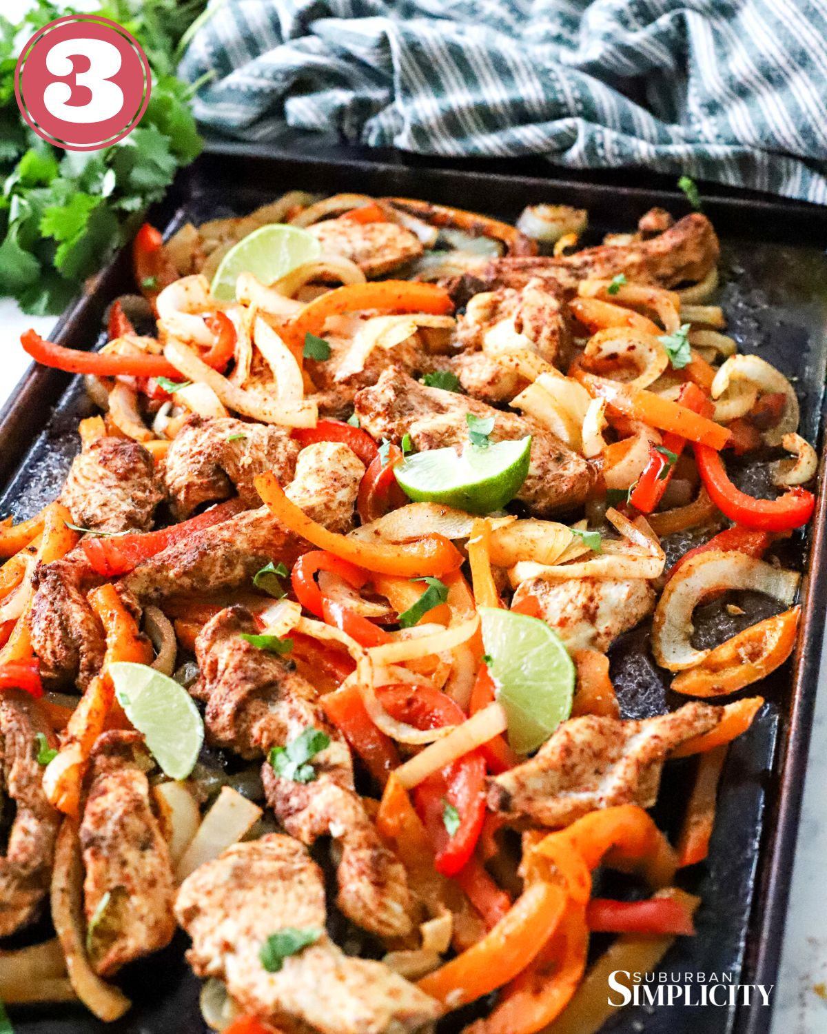 Baked chicken fajitas on a sheet pan with limes on top.