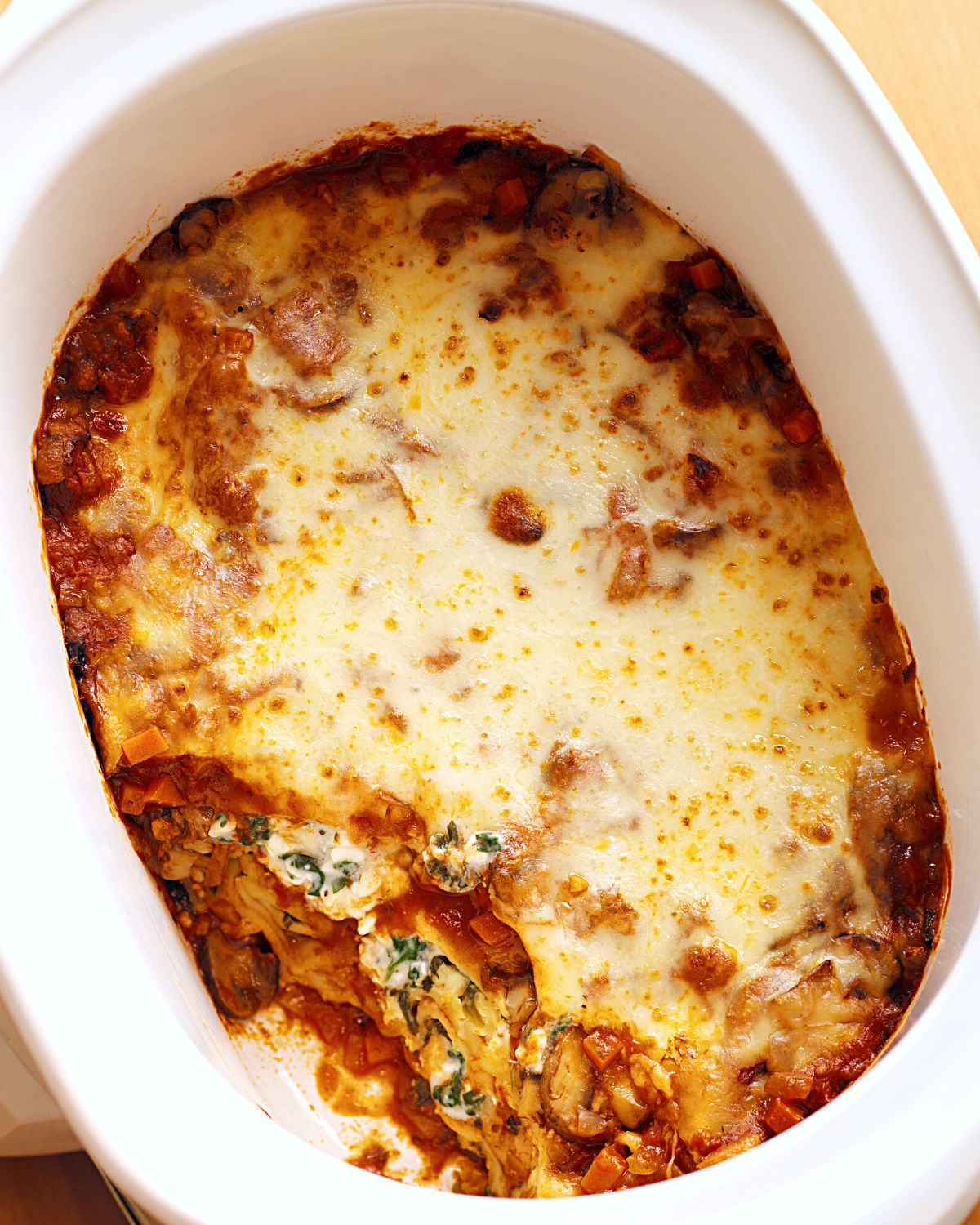 A slow cooker filled with vegetarian lasagna.