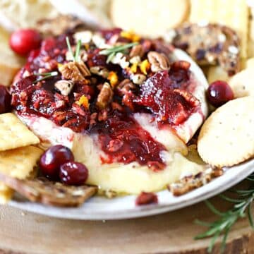 Baked Brie with cranberries on a plate.