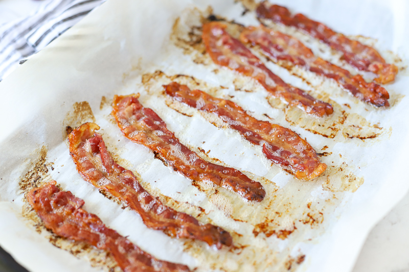 cooked bacon on a baking sheet