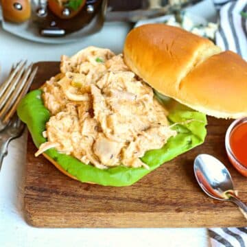 Slow cooked buffalo chicken in a sandwich.