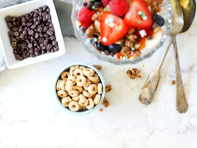 Cheerios in a bowl next to a breakfast sundae