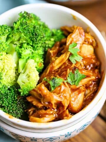 A Bowl full of honey garlic chicken with broccoli.