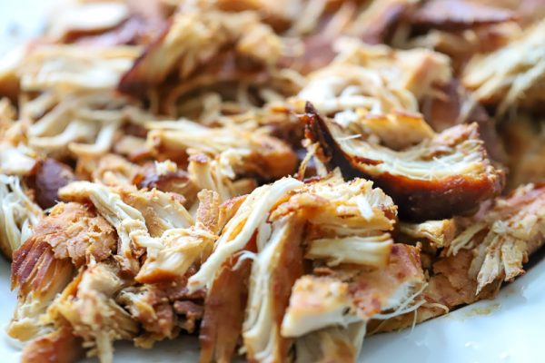 shredded chicken on cutting board