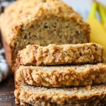 Banana bread topped with streusel cut into slices.