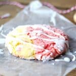 Strawberry lemonade cookie with icing on a piece of wax paper.