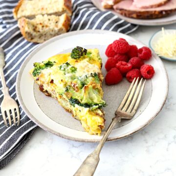 ham and cheese frittata on a plate with a fork.