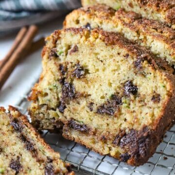 Zucchini Bread cut into slices on a cooling rack.