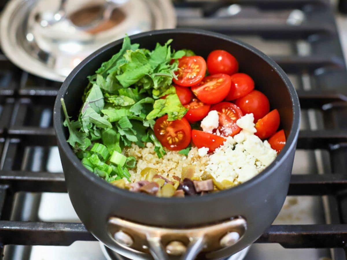 Ingredients to make Mediterranean quinoa salad in a pot.