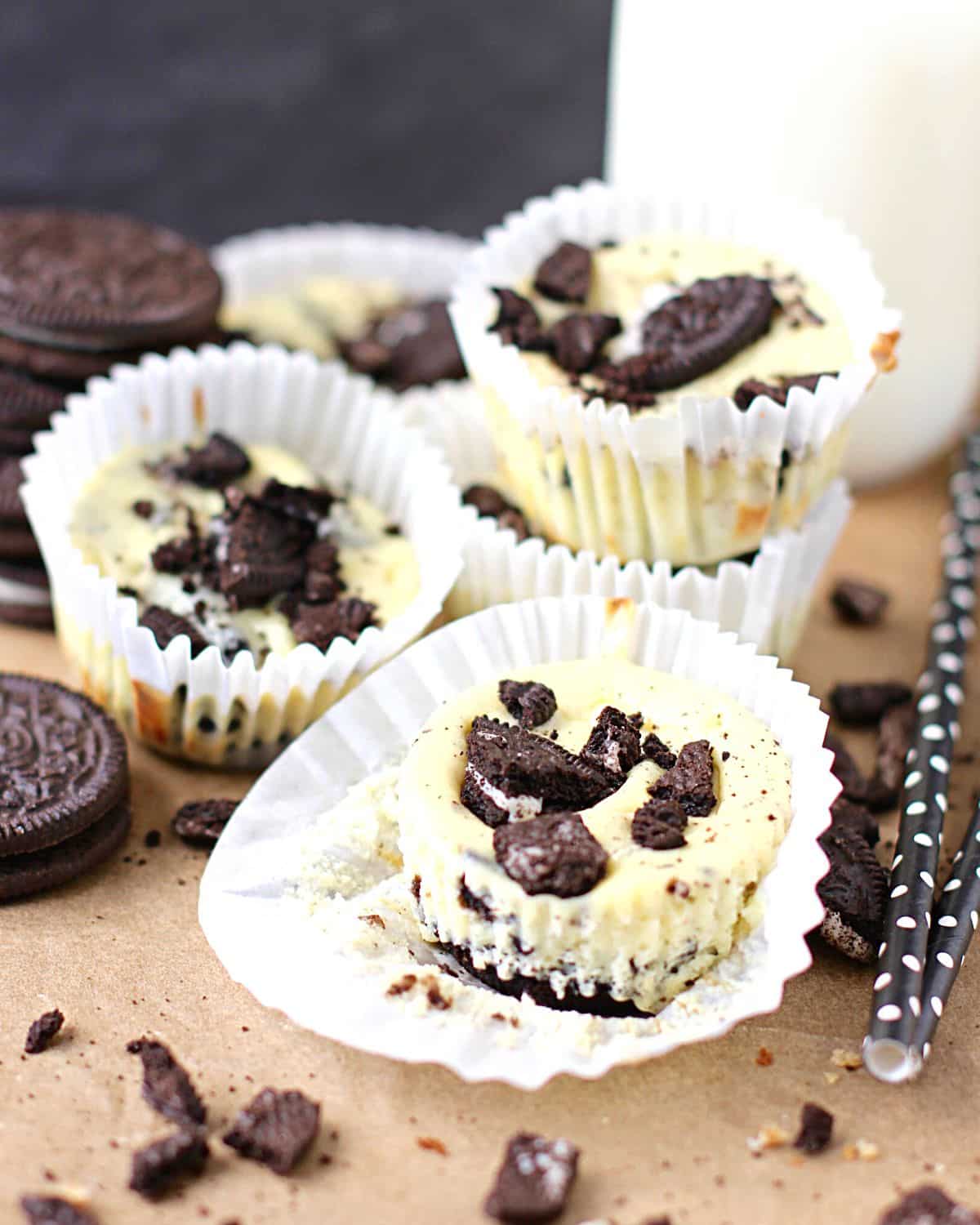 Mini Oreo cheesecakes with crushed Oreos on top.