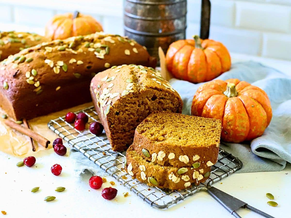 Two loaves of pumpkin bread on a wire rack.